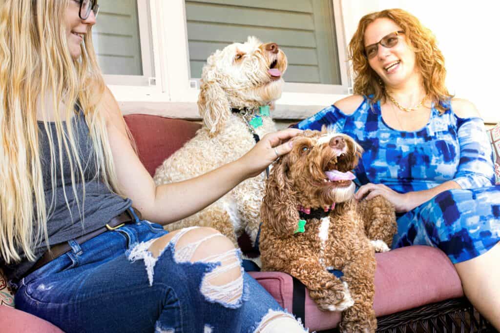 Mom and adult daughter talking with dogs between them
