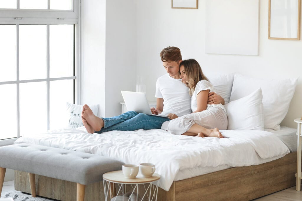 couple sitting on bed together